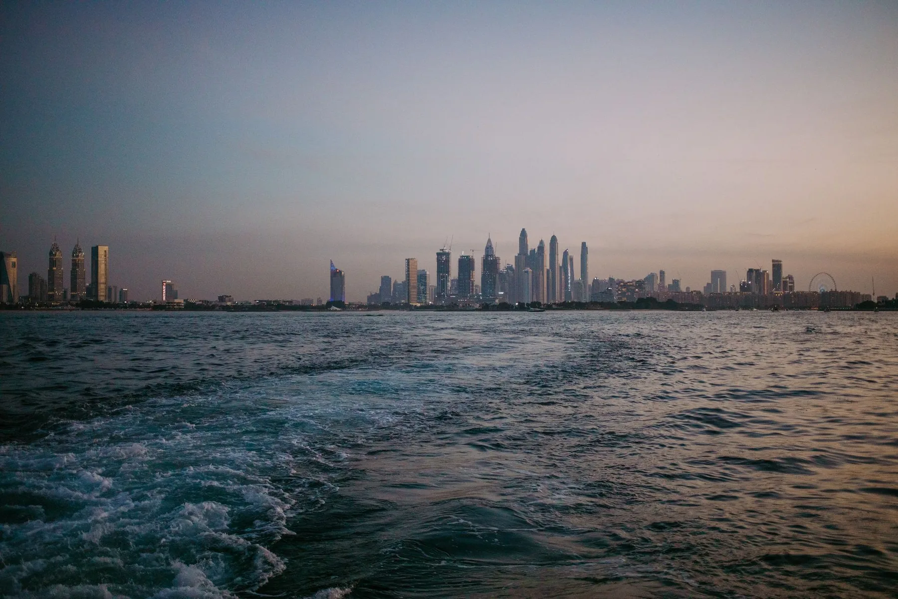 The Dubai skyline at dusk, seen from the sea